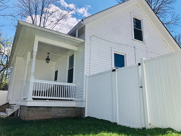 Side view of house and back porch from backyard.