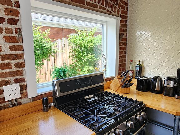 Detail of the stove, picture window and the coffee station.