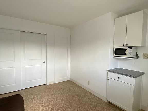 vue of the small kitchen cabinets with microwave