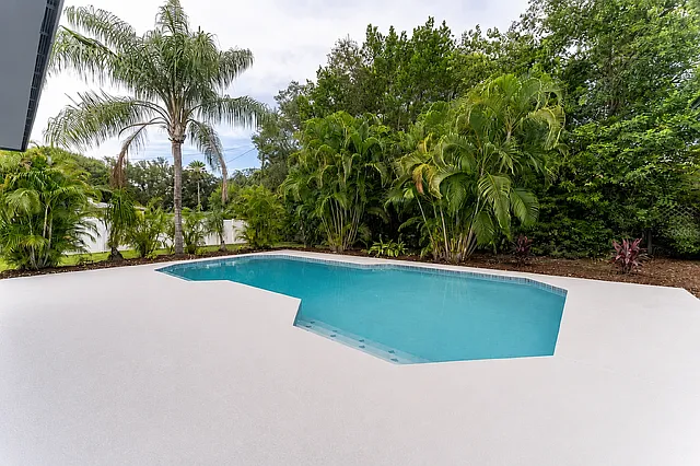 Fenced private backyard with pool, mature landscaping, and a fully private setting.
