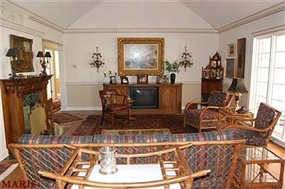 Great Room with wall of windows overlooks patio and backyard