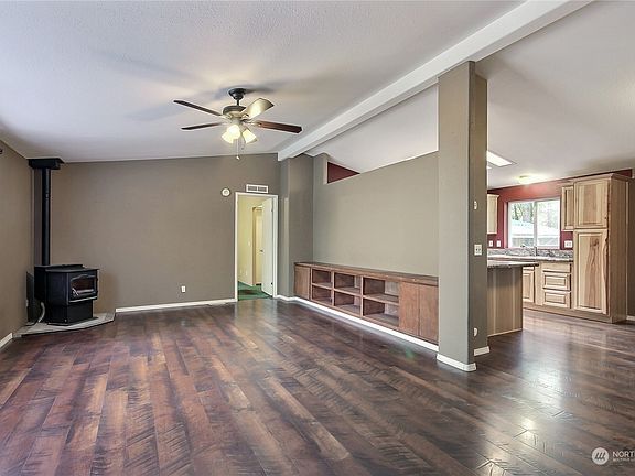 View from entry to family room with built-in bookcases and kitchen/dining. Master bedroom is straight ahead and note the vaulted ceilings. >