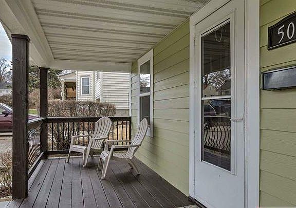 Great sitting porch in front of house. 
