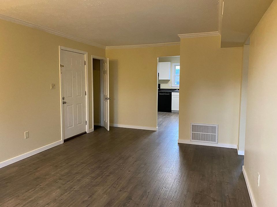 Living room with entrance door and closet.
