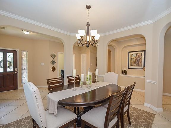 Beautiful architectural arches throughout the home. Crown molding adds the special touch to the ceiling. Upgraded chandelier.