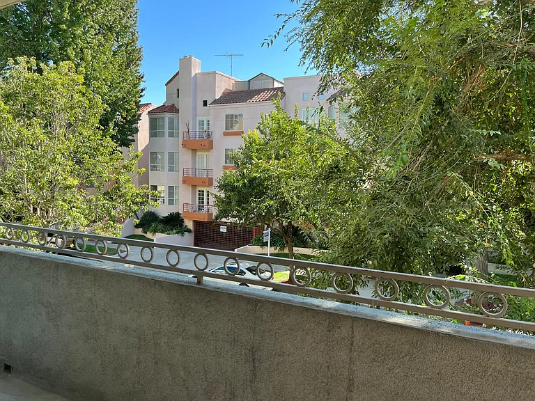 View from your private balcony over tree lined street.