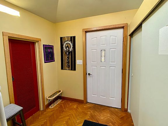 Front foyer, red door goes to utility room and coat closet on the right