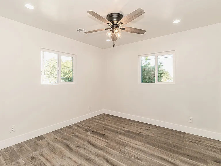 Bedrrom w/LVP Flooring, Dual Pane Windows, Fan and LED lighting.