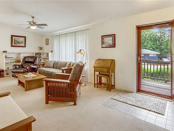 The open living room with vaulted ceilings & built-in book case is comfortable & inviting