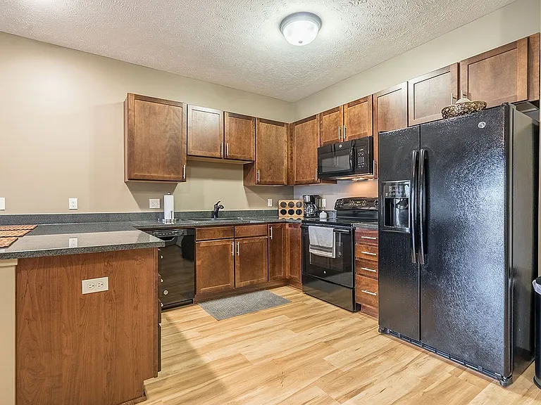 A modern kitchen with rich cabinetry and sleek finishes makes every meal feel like an experience.