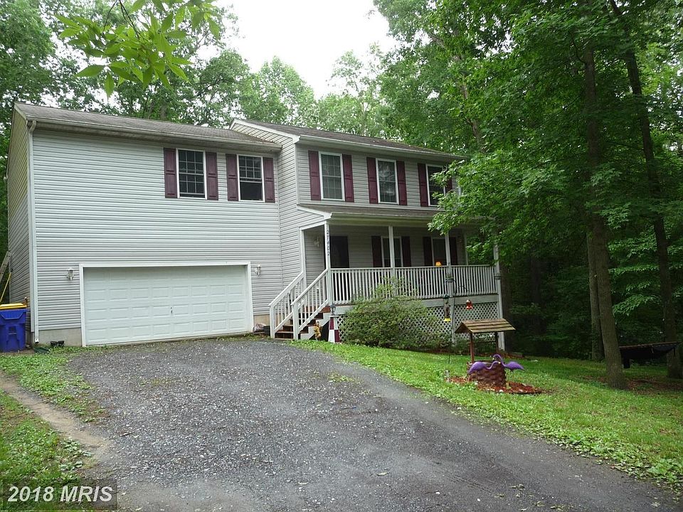 Wooded lot with front porch.
