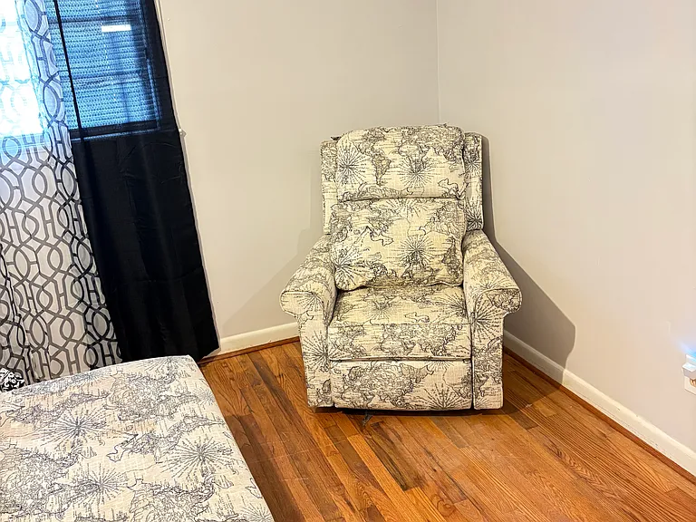 $900 bedroom, queen size bed and sitting chair.