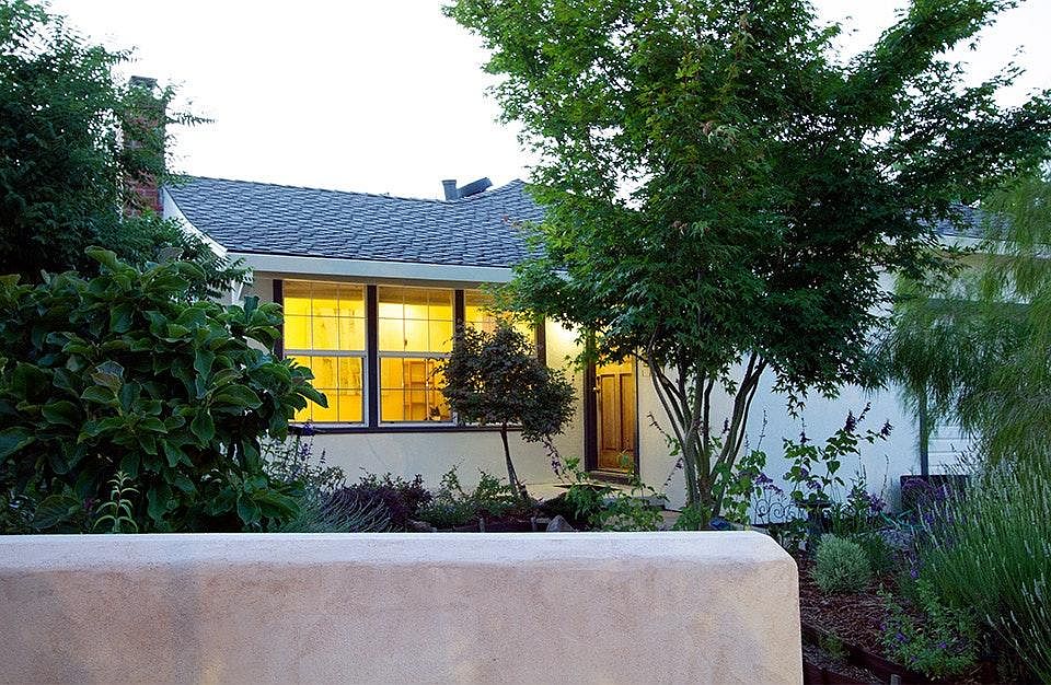 View from street towards front door. Front yard is now fenced in