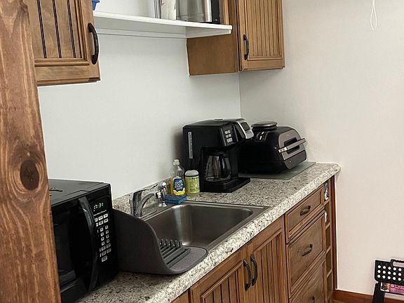 Kitchenette with Ninja Grill and Microwave. No conventional stove or oven.