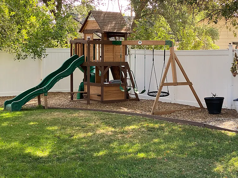 Play structure under mature trees