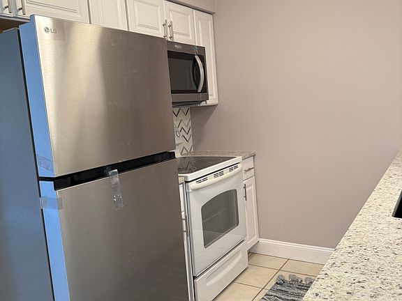 New cabinets, refrigerator, and microwave.