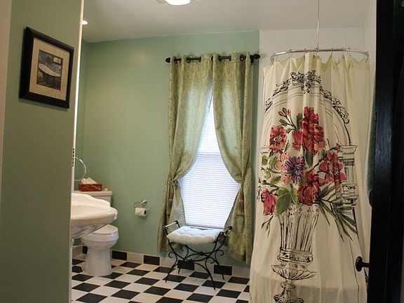 Claw foot tub behind curtain