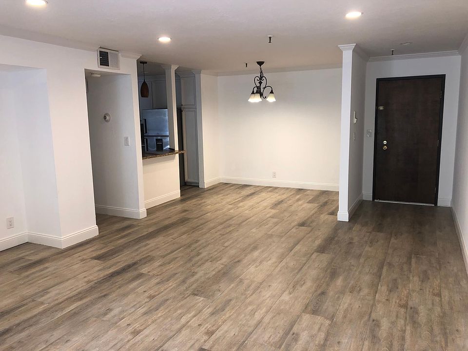Large spacious living room with hardwood floors throughout.