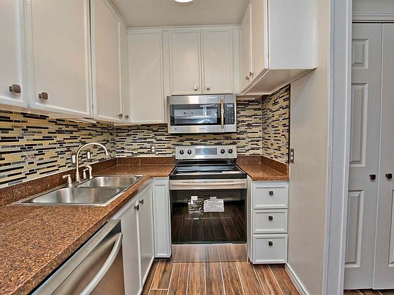 6x6 Kitchen - Built-in microwave with electric range below.