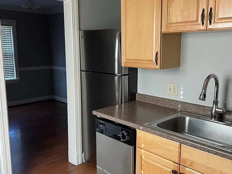 Kitchen includes gas stove, refrigerator, dishwasher, and garbage disposal.