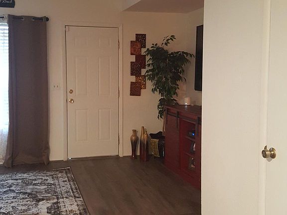 Past tenant's decorating touches (not included). Looking from dining area towards living room and patio.