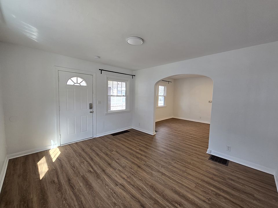 Living room with arch into dining room