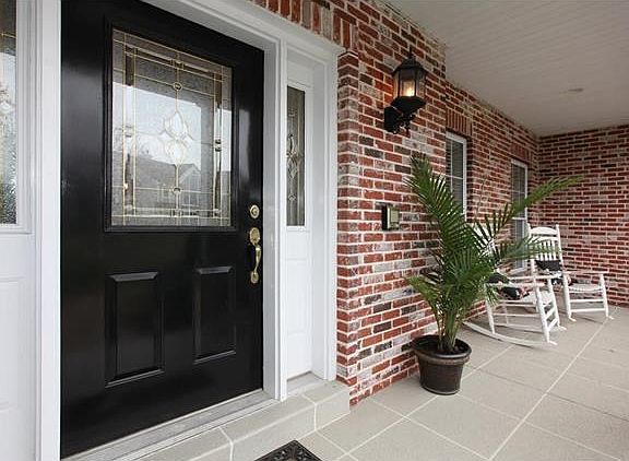 Inviting porch and beautiful front door.