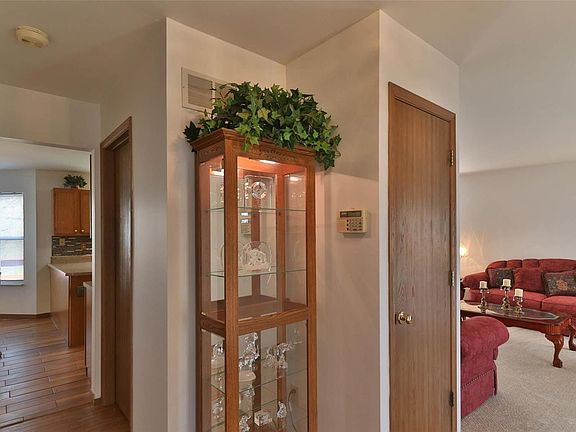 Entrance foyer with living room to the right, coat closet and half bath