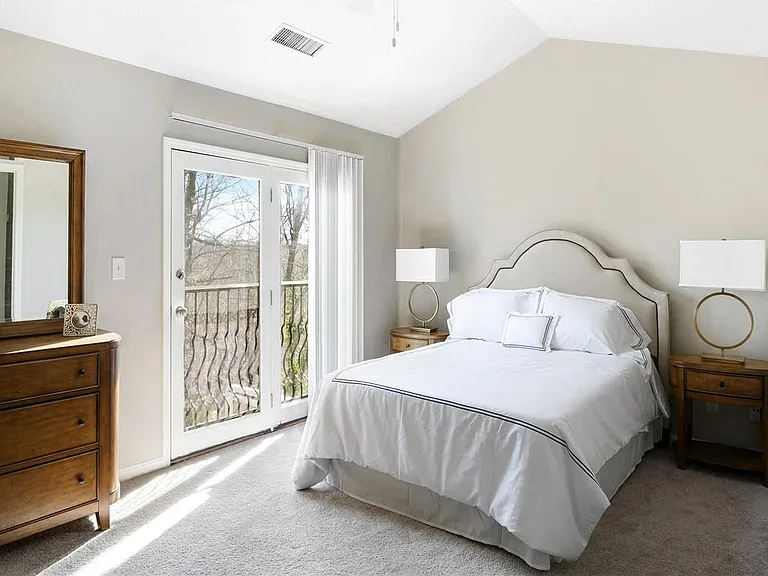 Spacious primary bedroom with vaulted ceiling
