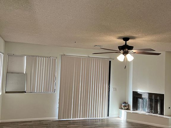 Living room with fire place and slider to front yard.