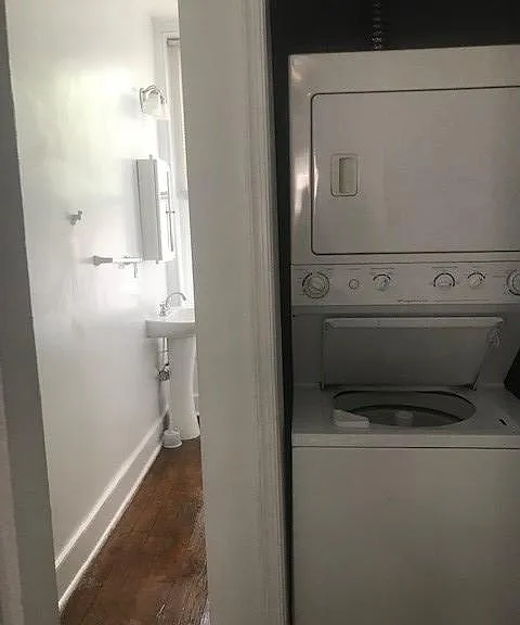 This bathroom, with washer and dryer, has a shower stall.