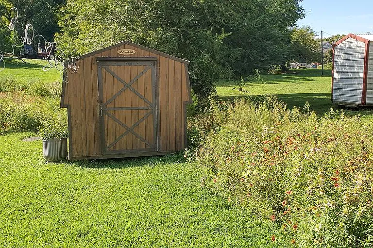 Shed for storage, outdoor lights and perimeter native meadow.