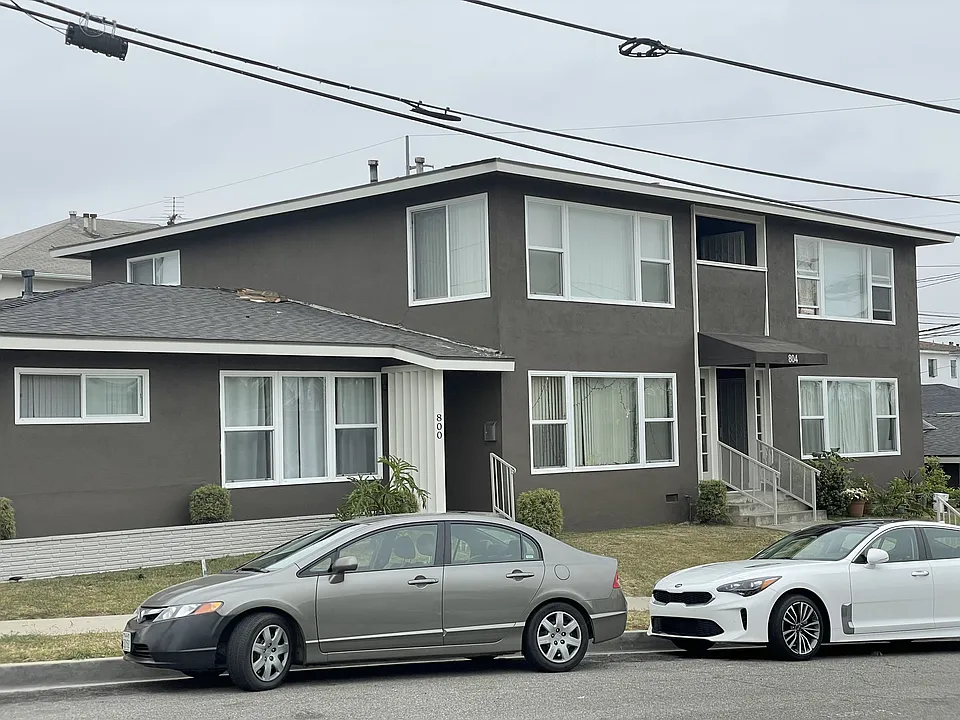 The building sets up high on a corner lot with a city view