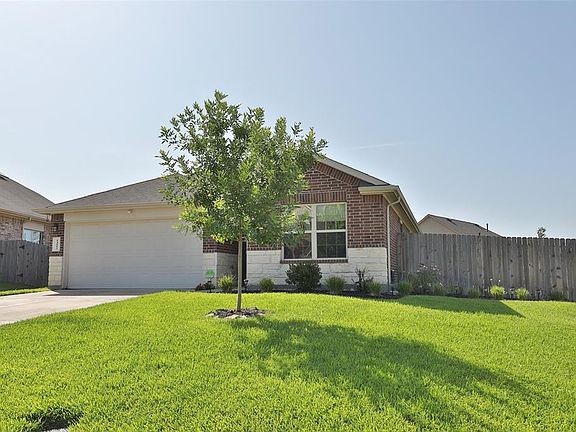 The home offers a dramatic stone and brick front elevation on a large corner lot.