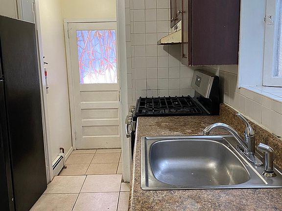 Kitchen with view of door to backyard.