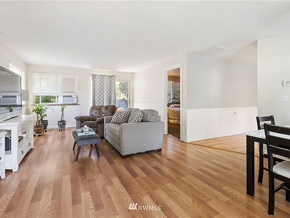 Gorgeous original floors shines bright! Those double-pane windows pull the sunlight in to this open, bright & airy living space. 