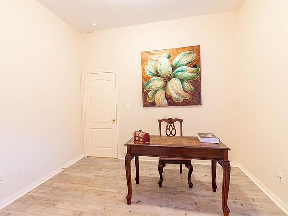Nestled away quietly in the front of the home is the handsome home office! Featuring high ceilings, custom paint, and beautiful flooring!