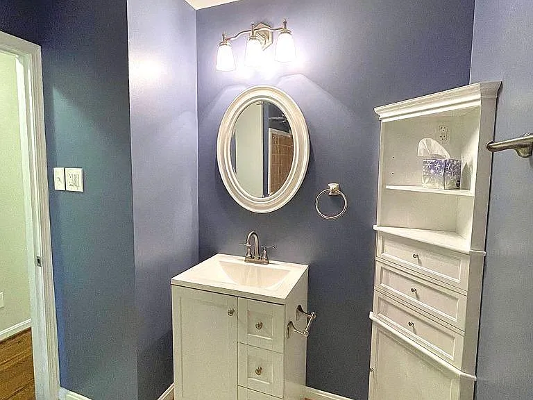 Upper level full bathroom with a tub - hallway