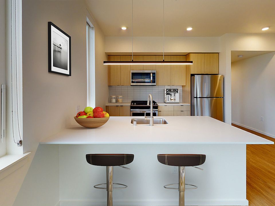 Beautiful kitchens with custom wood cabinetry, quartz countertops, subway tile backsplash, and stainless steel appliances
