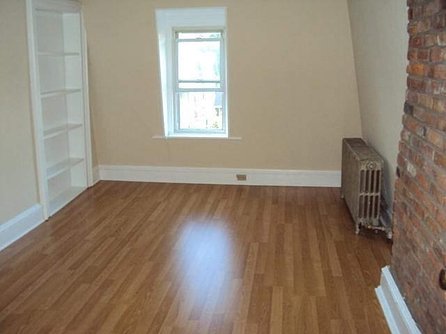 Living Room with exposed brick and bookcase