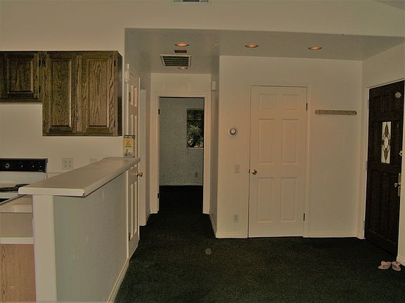 Family room facing bedroom before new paint & carpeting