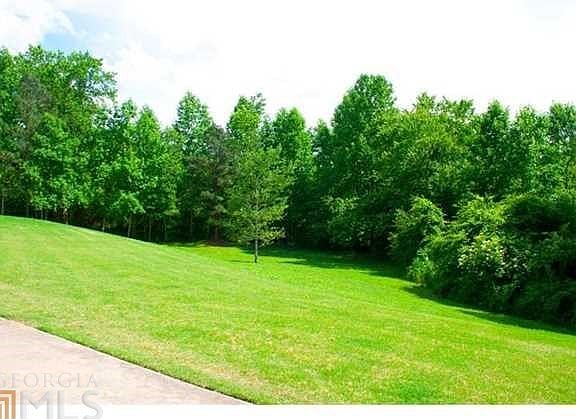 Large rolling landscape. Professionally landscaped. Rock patio and fire pit in backyard. Screened in
