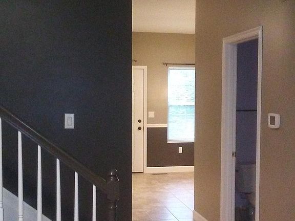 View from living room towards back door. Half bath located on the right.