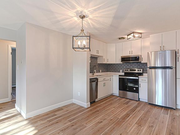Beautiful Kitchen with white Cabinets, new SS appliances, Quartz counters, quiet Disposal.
