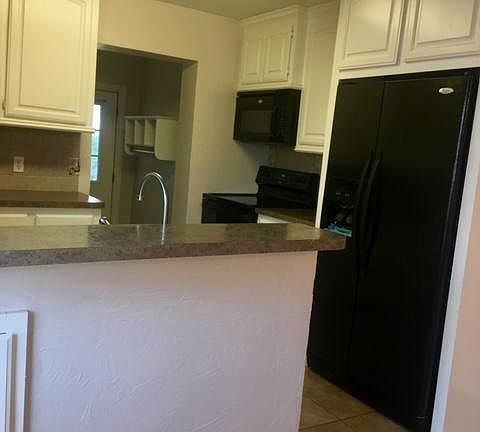 Kitchen. Stove, refrigerator, dishwasher, and microwave included. Laundry room off the kitchen. Washer and Dryer hook ups.