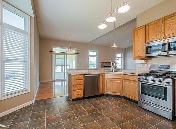 Another great look at the kitchen with the bay window and atrium windows above.