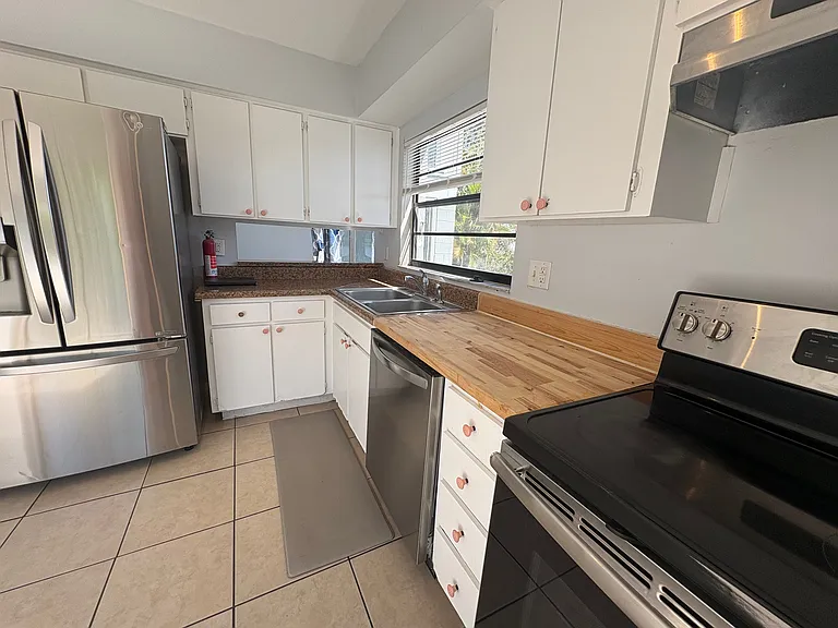 butcher block counter and stainless appliances