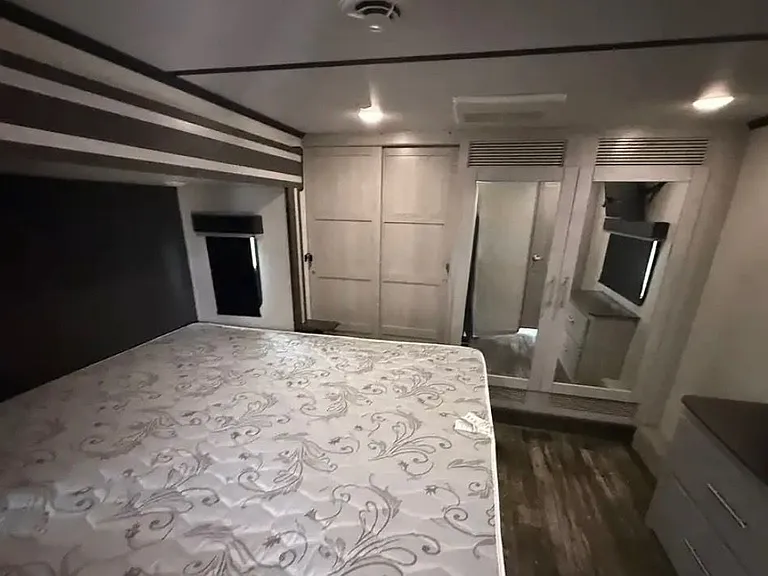 bedroom w/ king bed, closet, and laundry