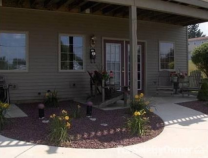 Landscaping : Beautiful red stone throughout front and back landscapes.