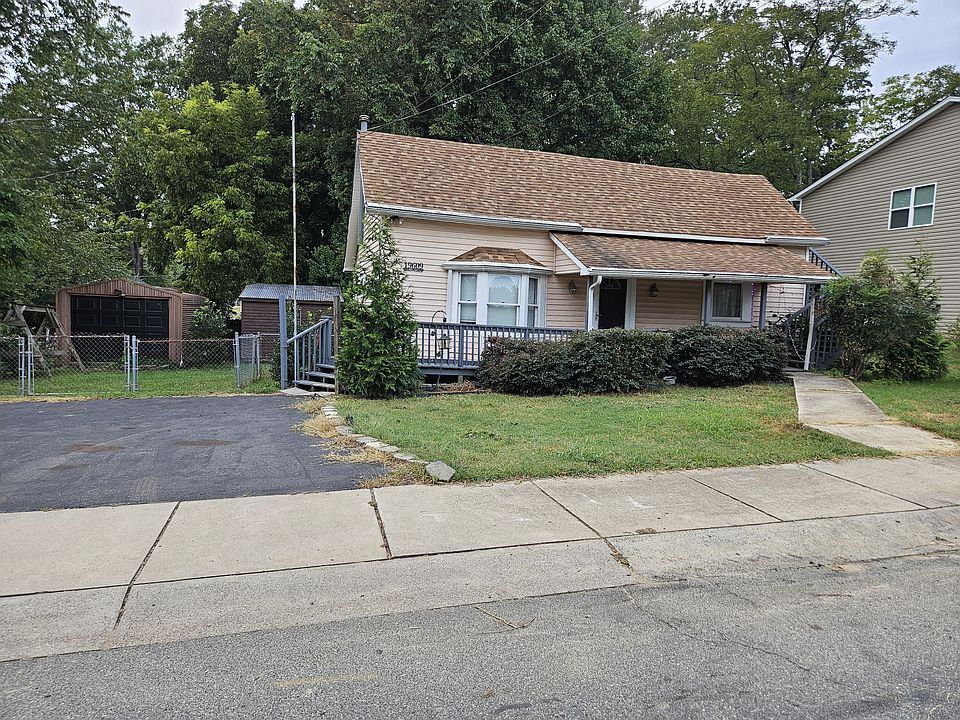 Full front covered porch, asphalt parking for three vehicles